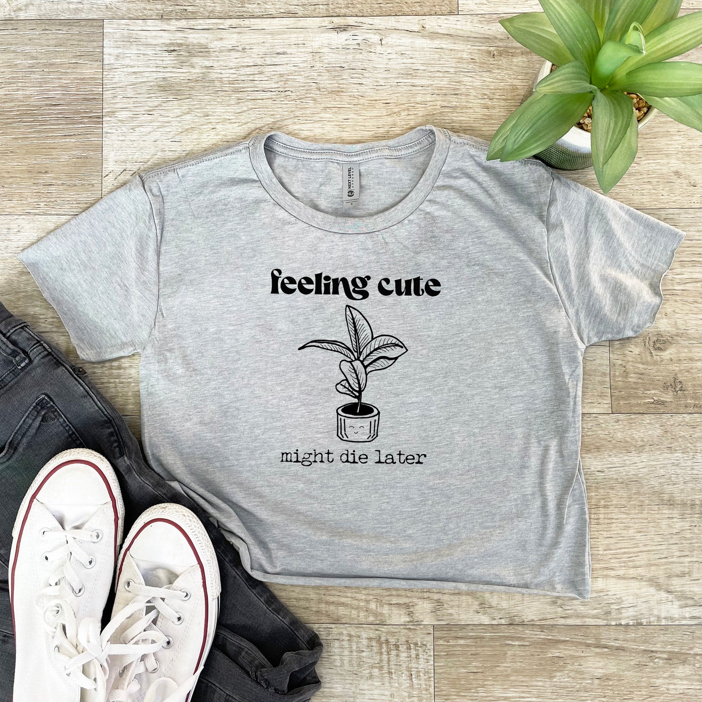 a t - shirt that says feeling cute might be later next to a pair of