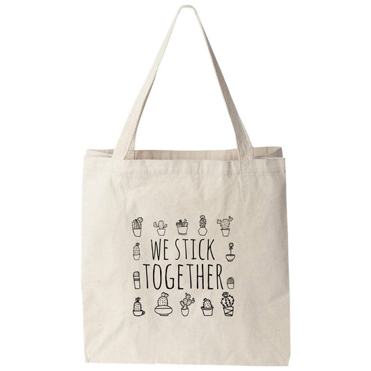 a tote bag that says we stick together