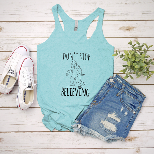 a women's tank top that says, don't stop believing