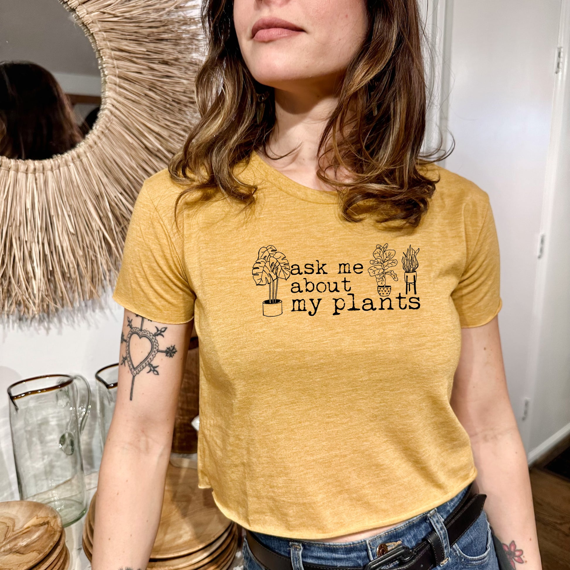 a woman wearing a t - shirt that says ask me about my plants