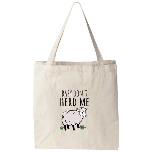 a tote bag that says baby don't herd me