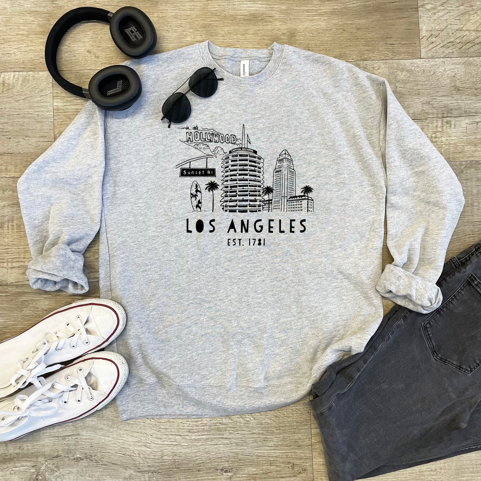 a sweatshirt with headphones, headphones, and a pair of jeans