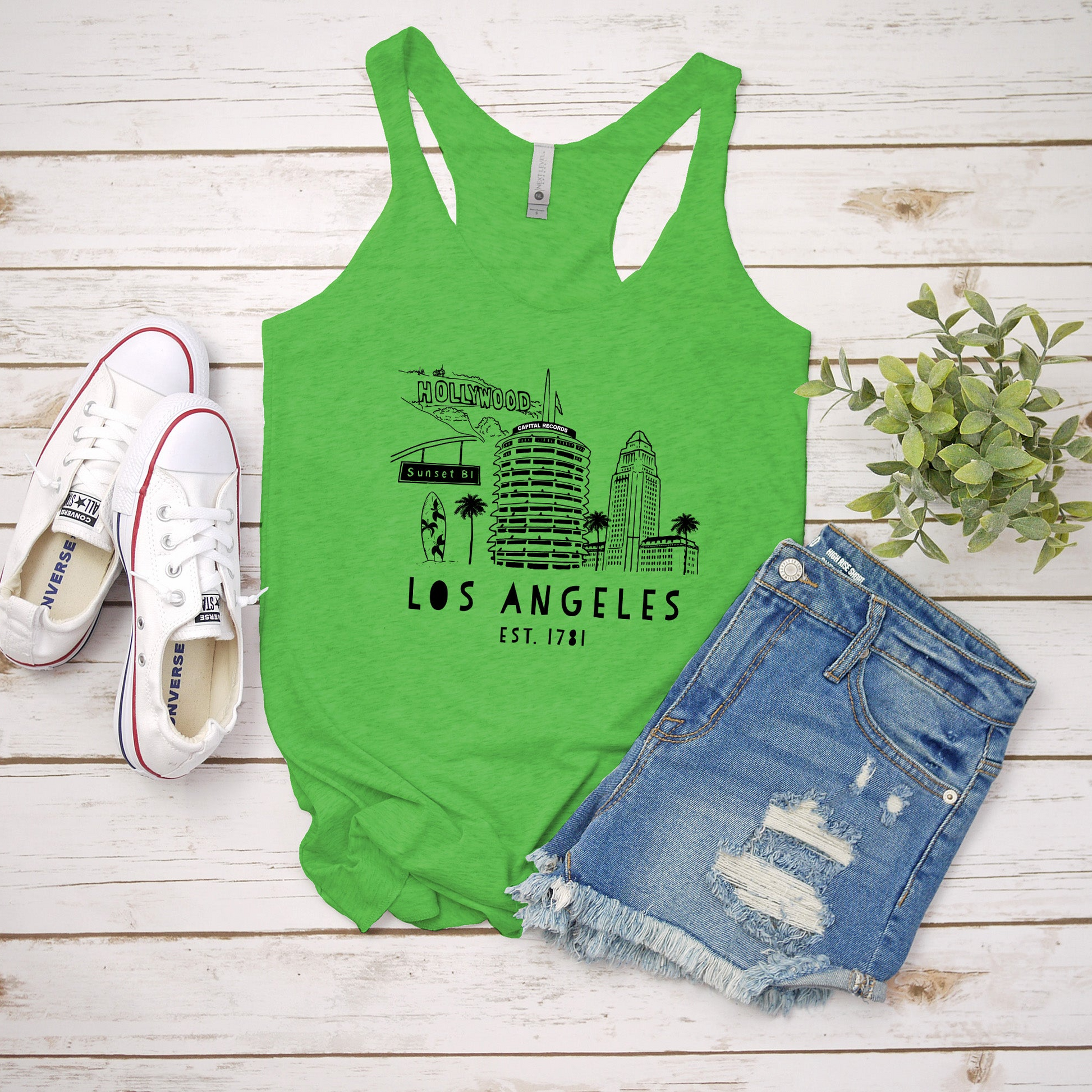 a green tank top with the los angeles skyline on it