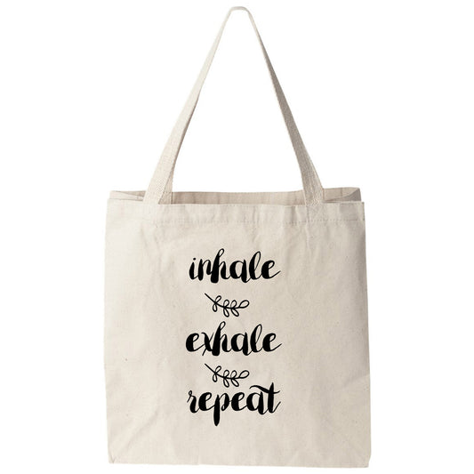 a white tote bag with black lettering that says, ultimate exhale and repeat