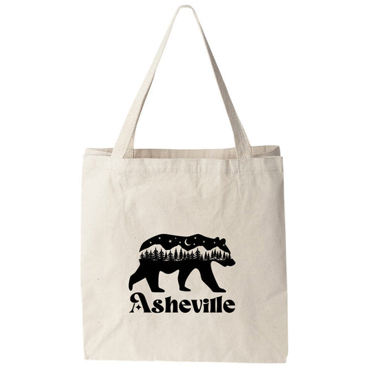 a white tote bag with a bear and trees on it