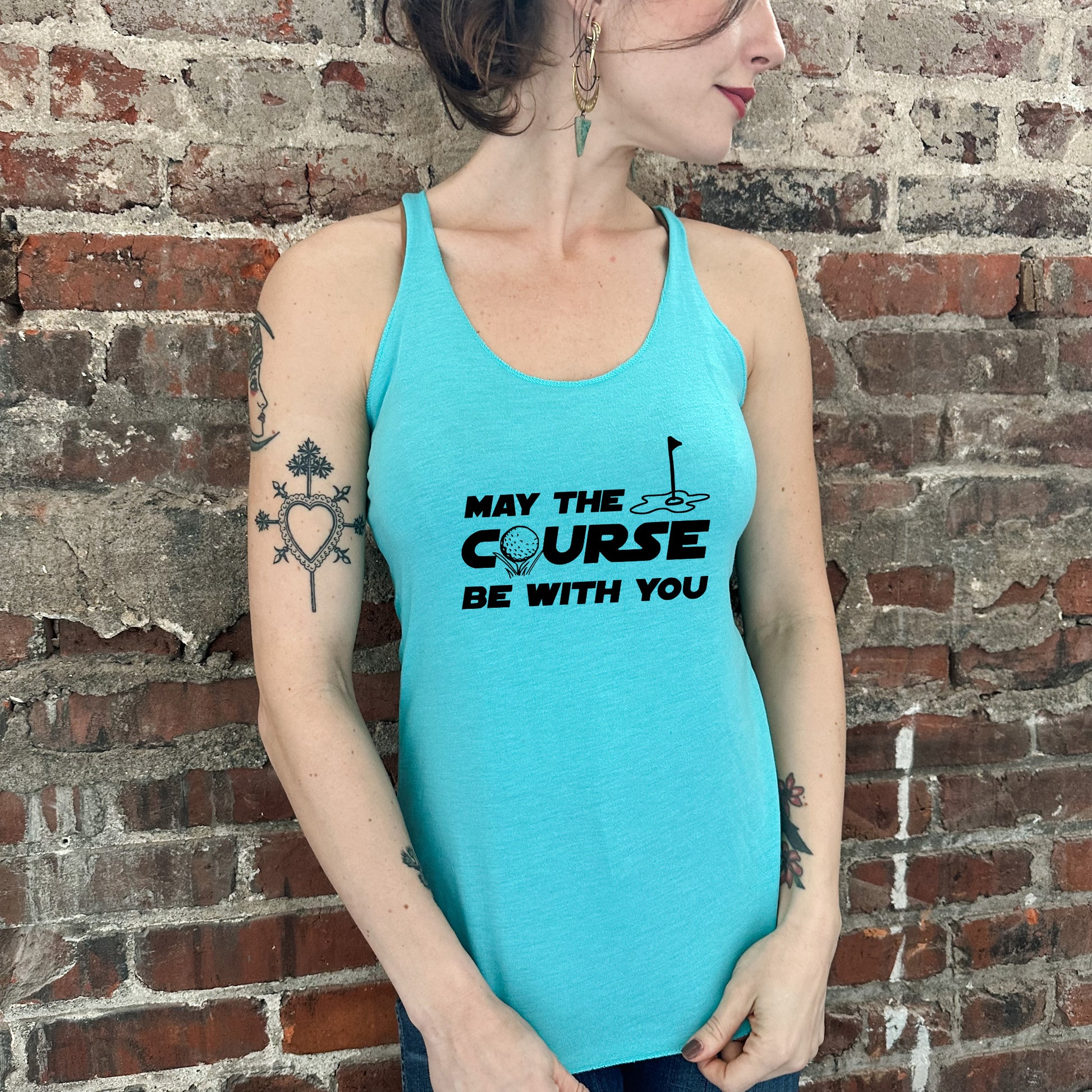 a woman wearing a blue tank top with the words, may the course be with