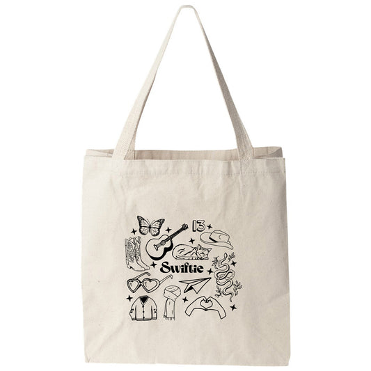 a white tote bag with a picture of a guitar and other items