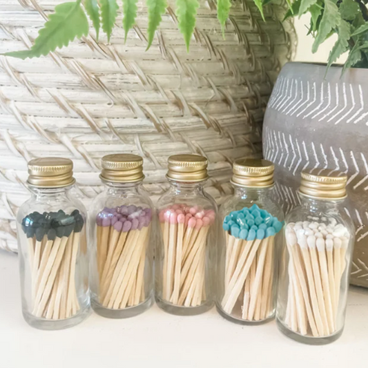 a group of small glass bottles filled with matches