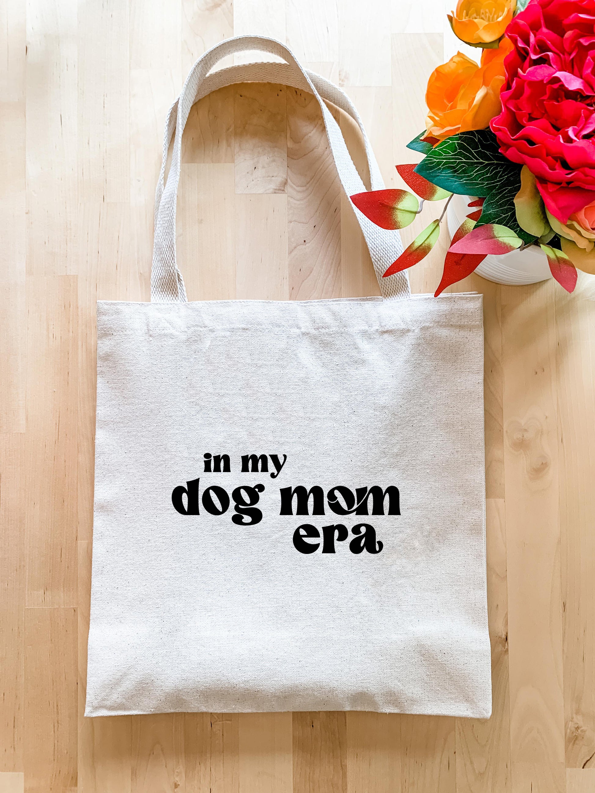 a white tote bag with the words, in my dog mom era on it
