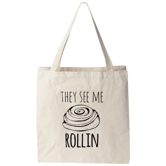 a tote bag that says, they see me rollin