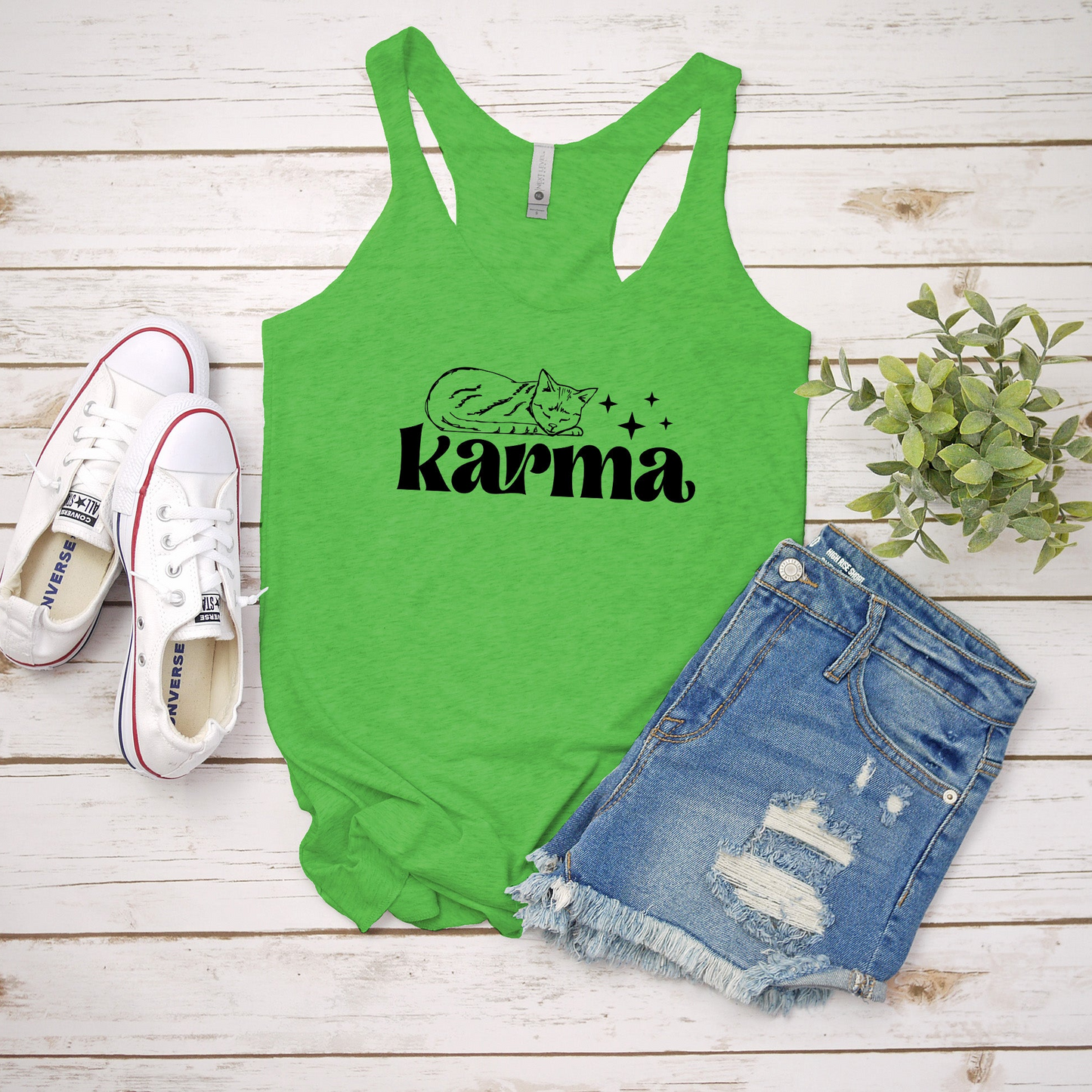 a green tank top that says karmia next to a pair of shorts