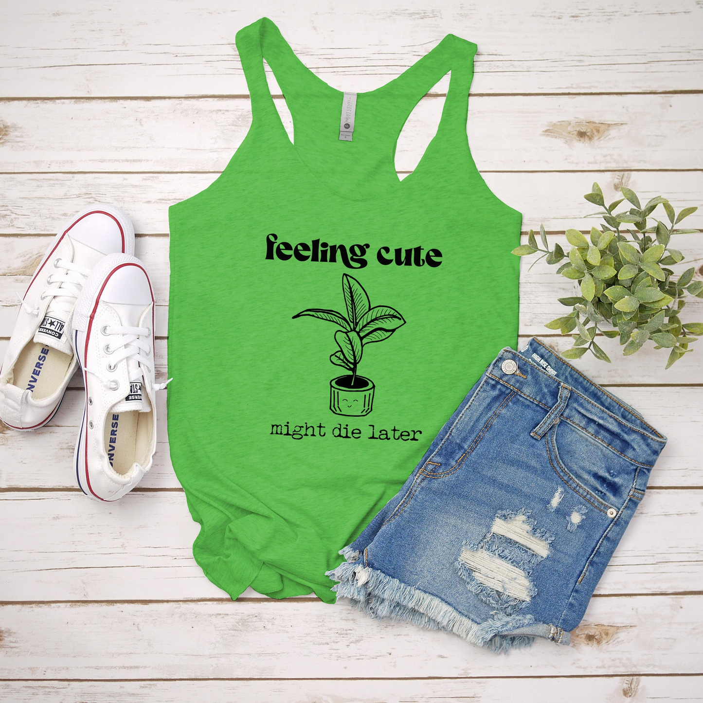 a green tank top with a plant on it