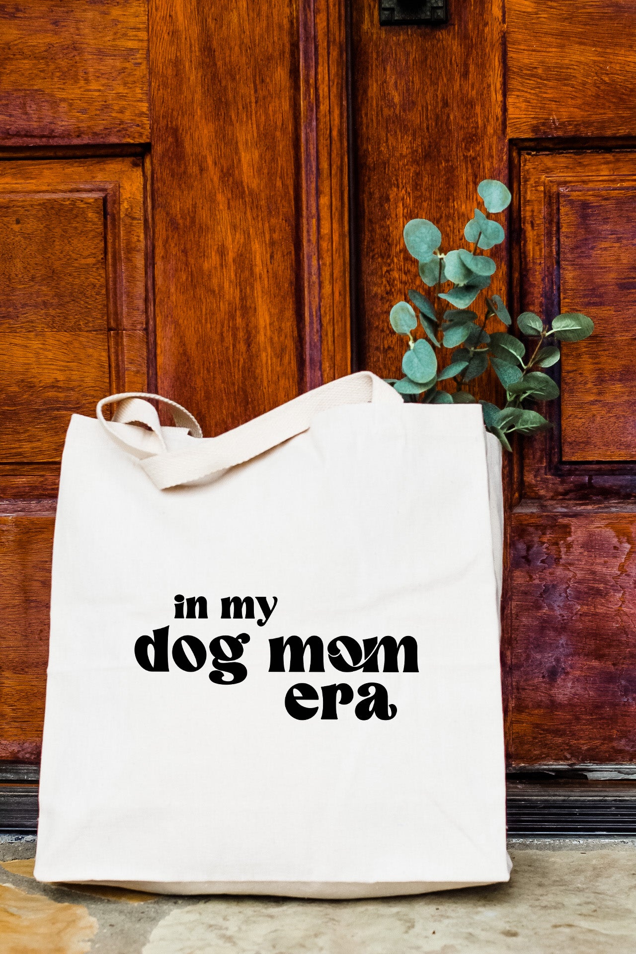 a white bag with the words in my dog mom era printed on it