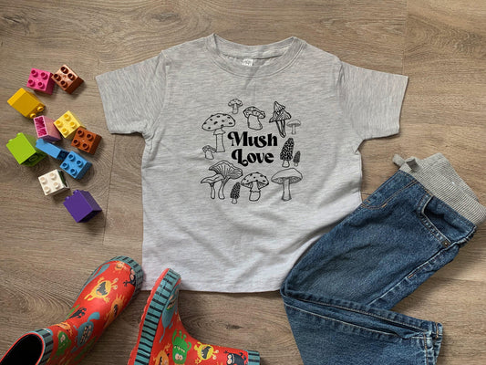 a child's t - shirt with a picture of mushrooms on it