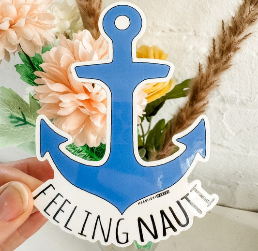 a person holding a sticker with an anchor on it