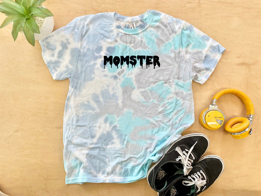 a t - shirt with the word monster on it next to headphones and a