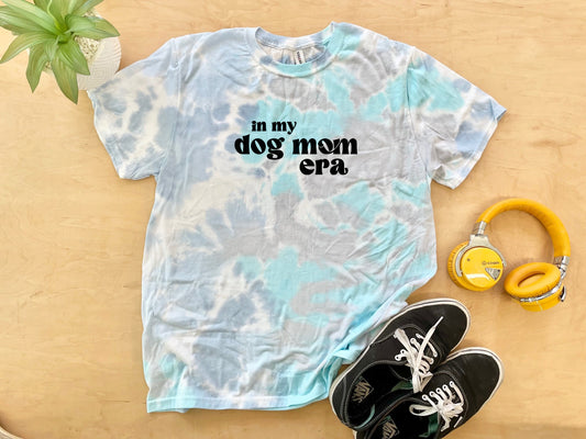 a t - shirt that says in my dog mom cap next to a pair of