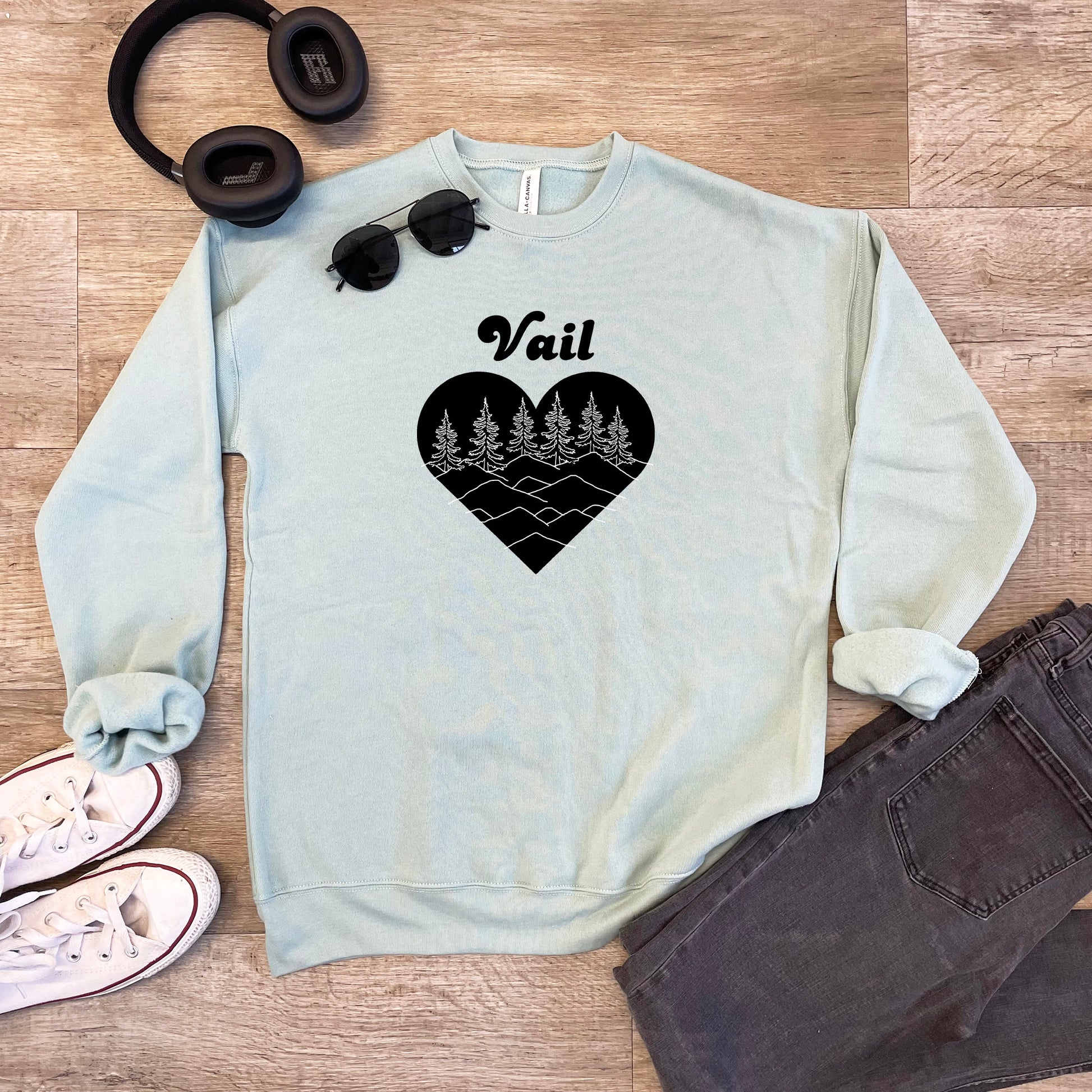 a pair of headphones and a sweatshirt with a heart on it