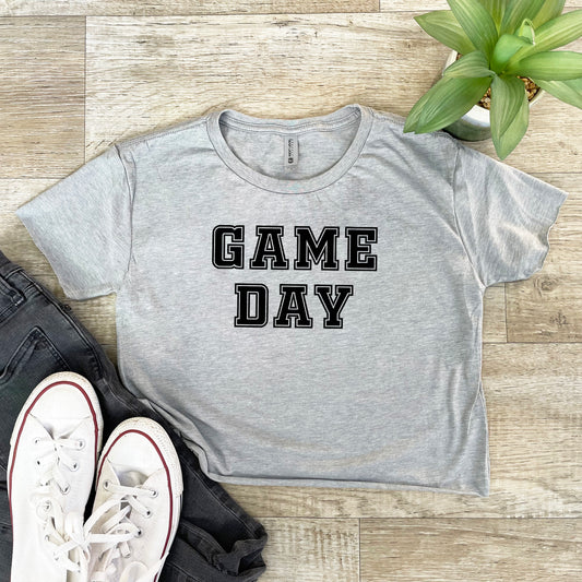 a t - shirt that says game day next to a pair of sneakers