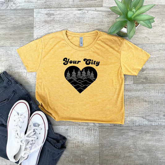 a yellow t - shirt with a black heart that says your city