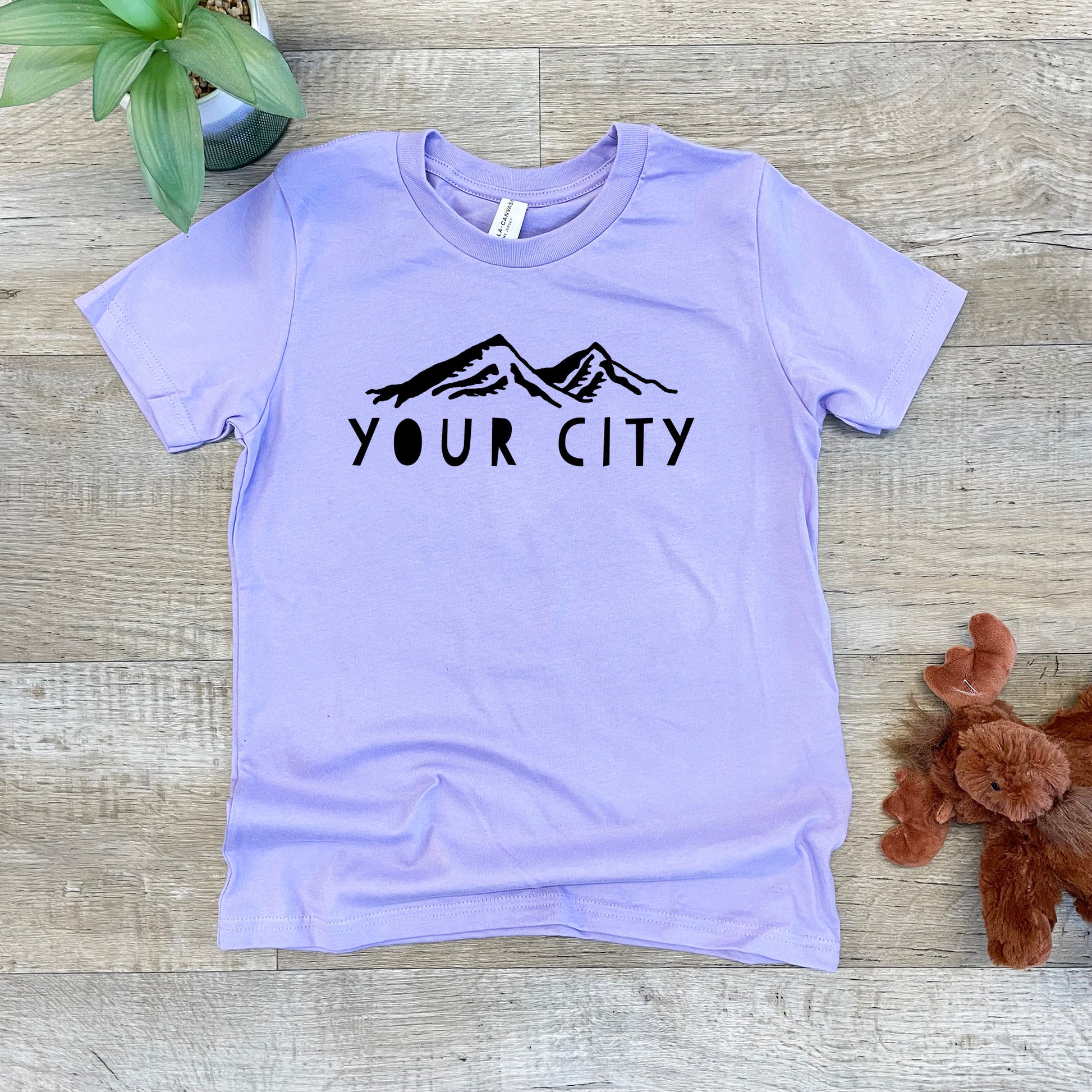 a t - shirt that says your city next to a teddy bear