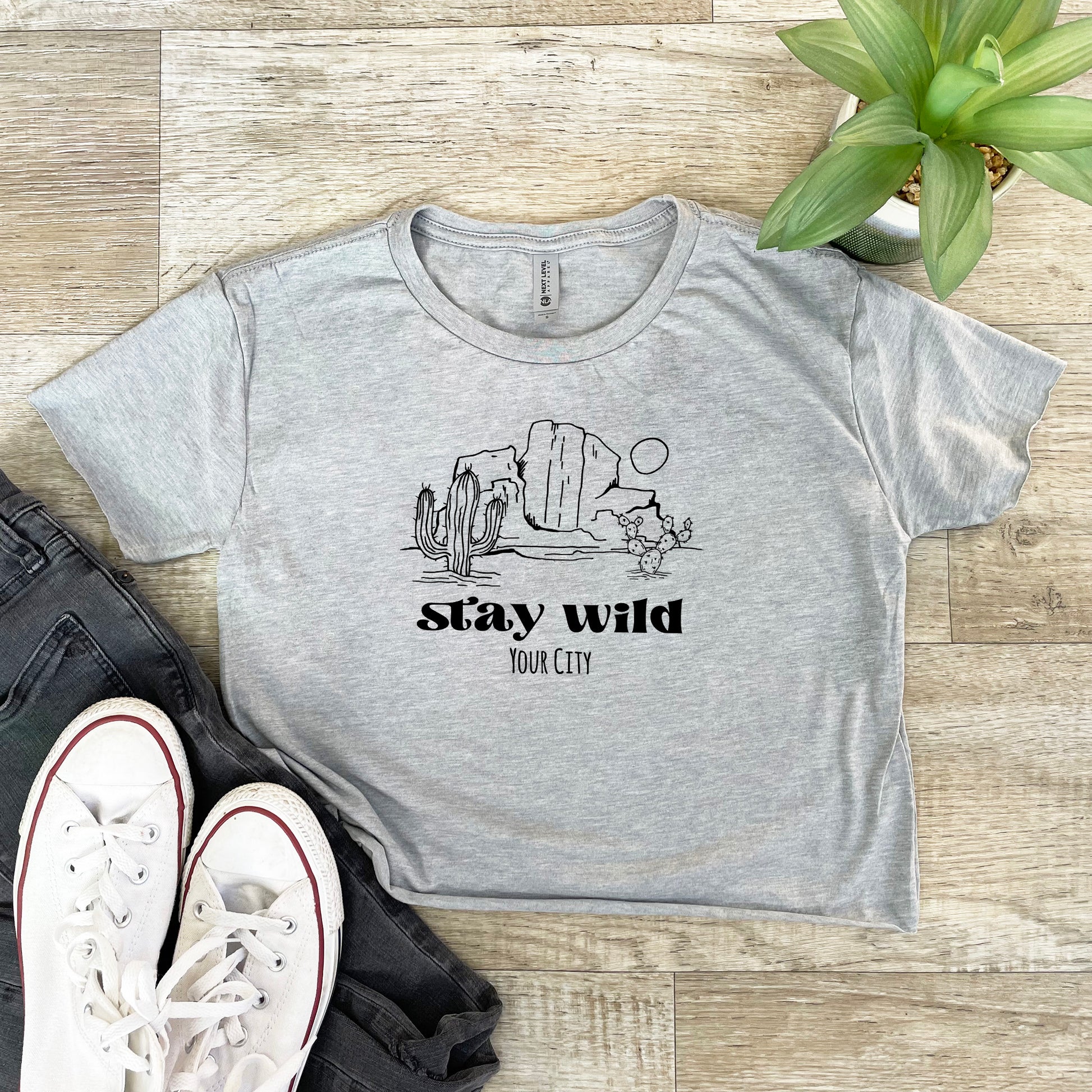 a t - shirt that says stay wild and a pair of sneakers