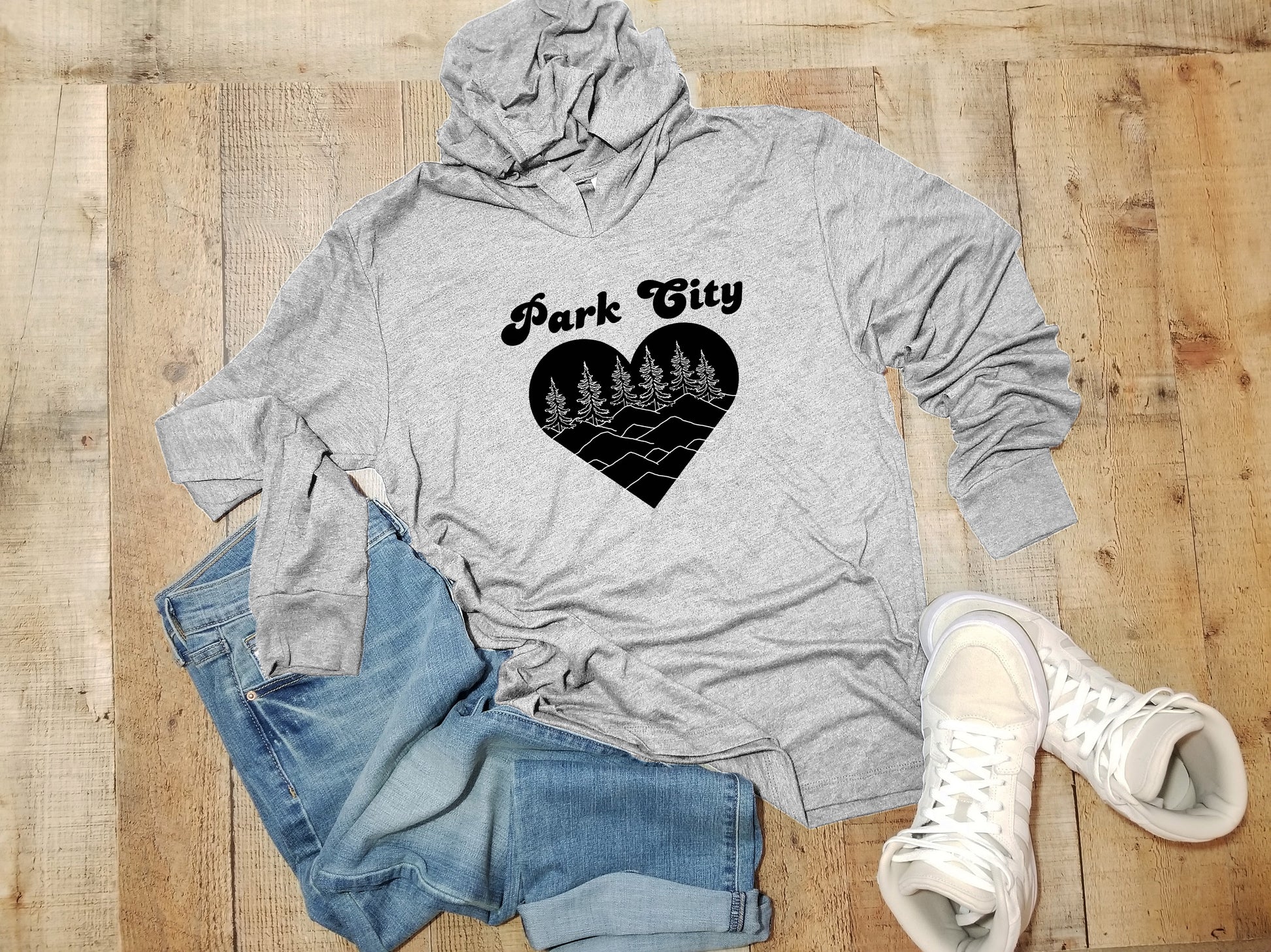 a grey hoodie with a black heart that says park city