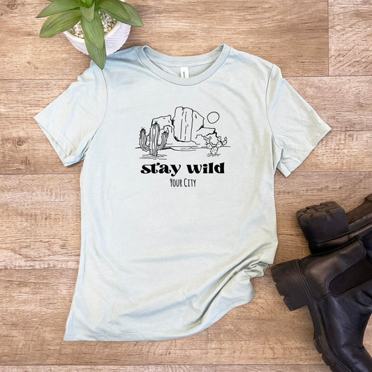 a t - shirt that says stay wild with a cactus in the background