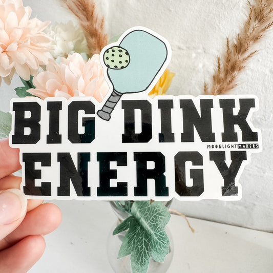 a hand holding a sticker that says, big drink energy