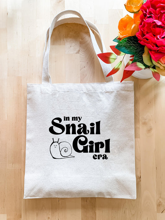 a white tote bag with a snail on it