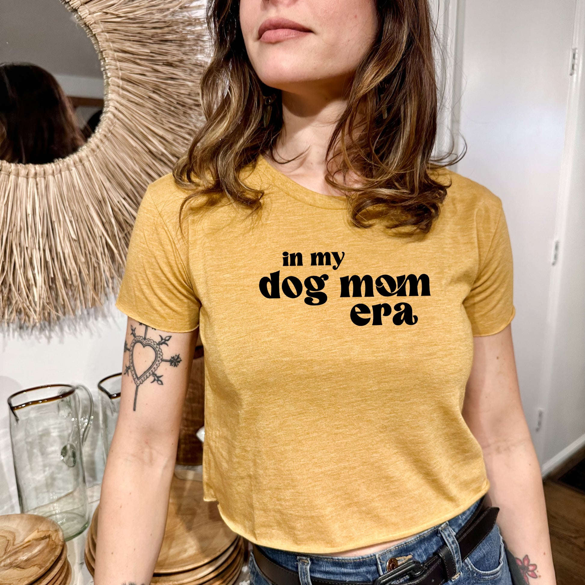 a woman wearing a t - shirt that says in my dog mom era