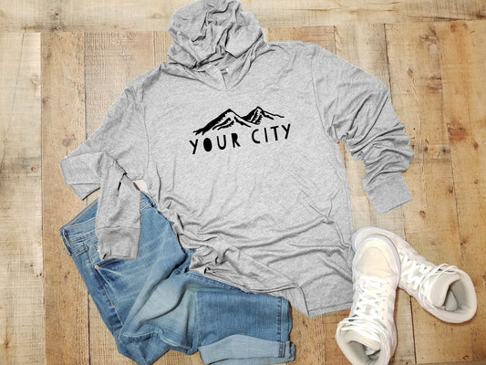 a grey hoodie with the words your city printed on it