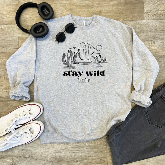a sweatshirt that says stay wild with headphones on top of it