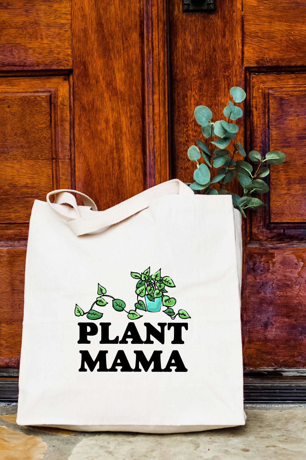 a plant mama bag sitting in front of a door