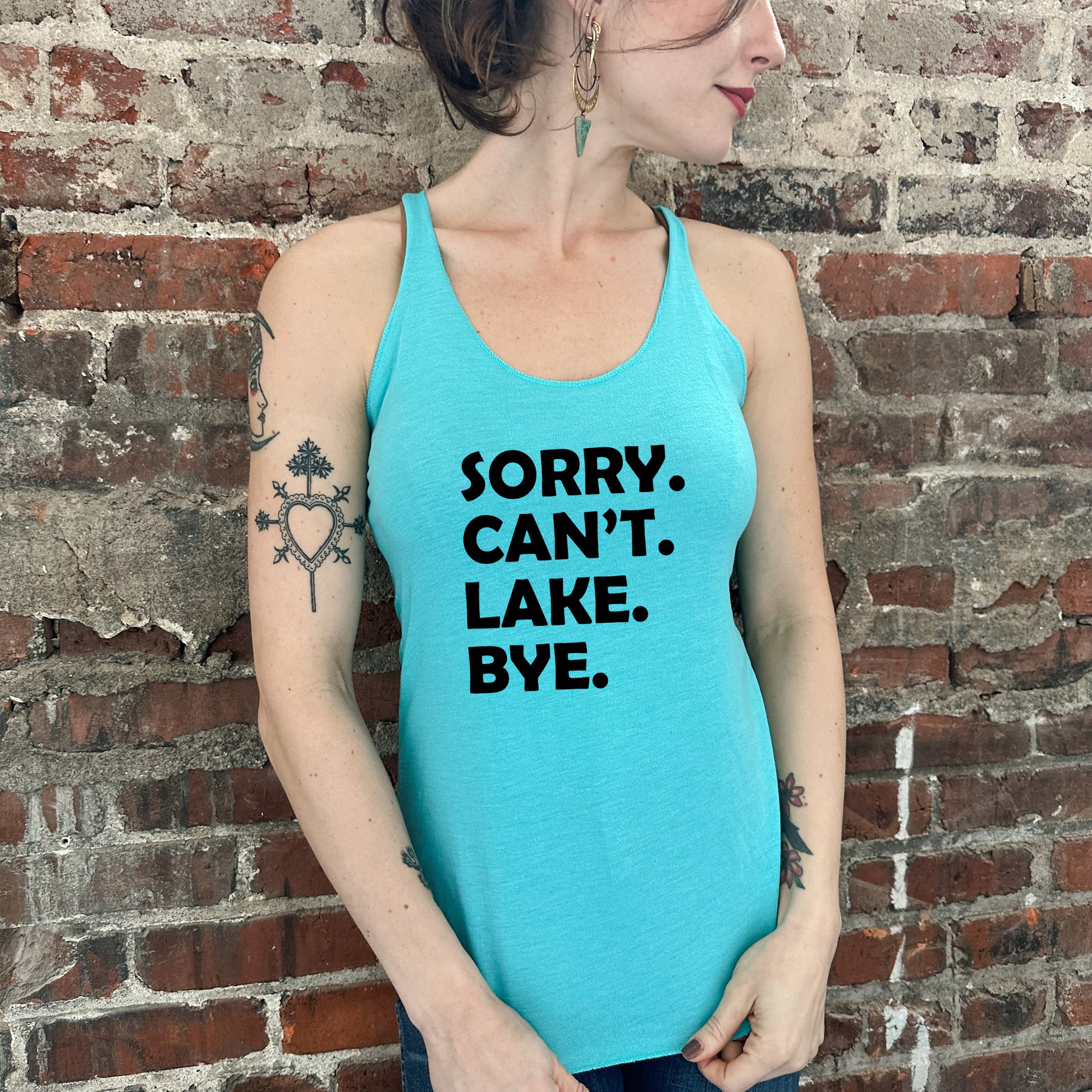 a woman wearing a tank top that says sorry, can't lake bye