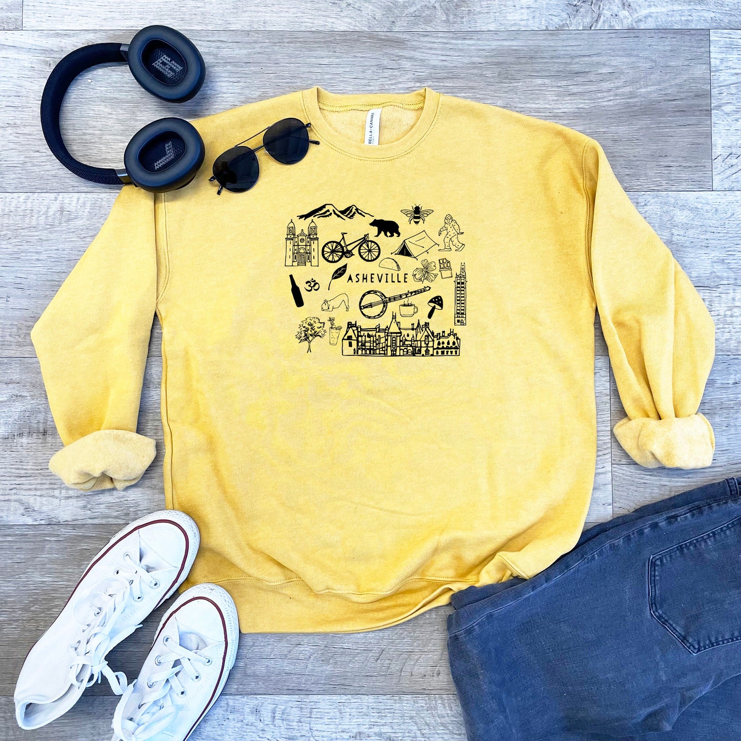 a yellow sweatshirt with a picture of a cat and a pair of headphones