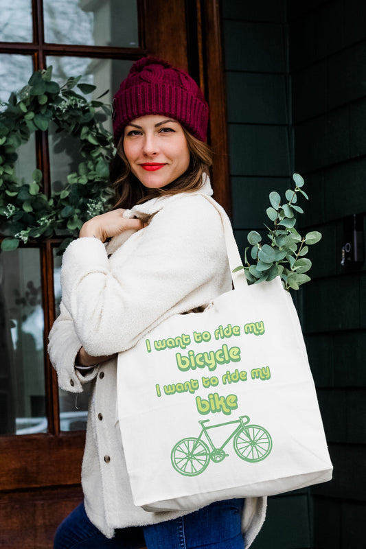 a woman carrying a bag with a bicycle on it