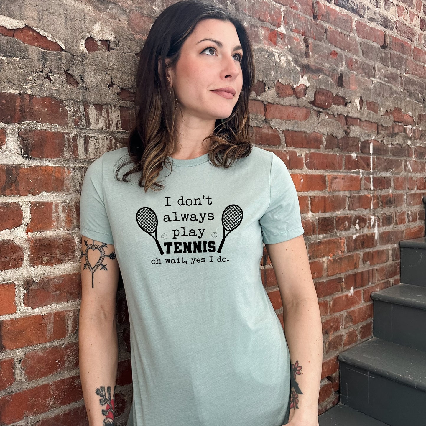 a woman standing in front of a brick wall