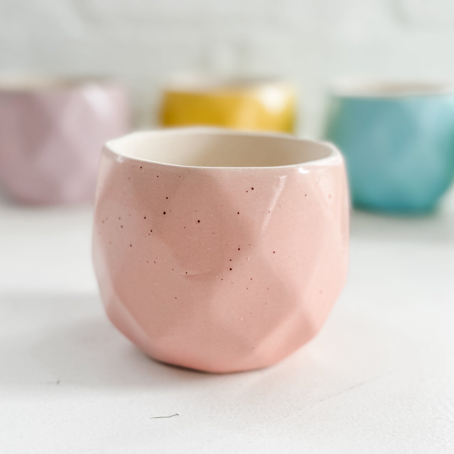 a close up of three cups on a table