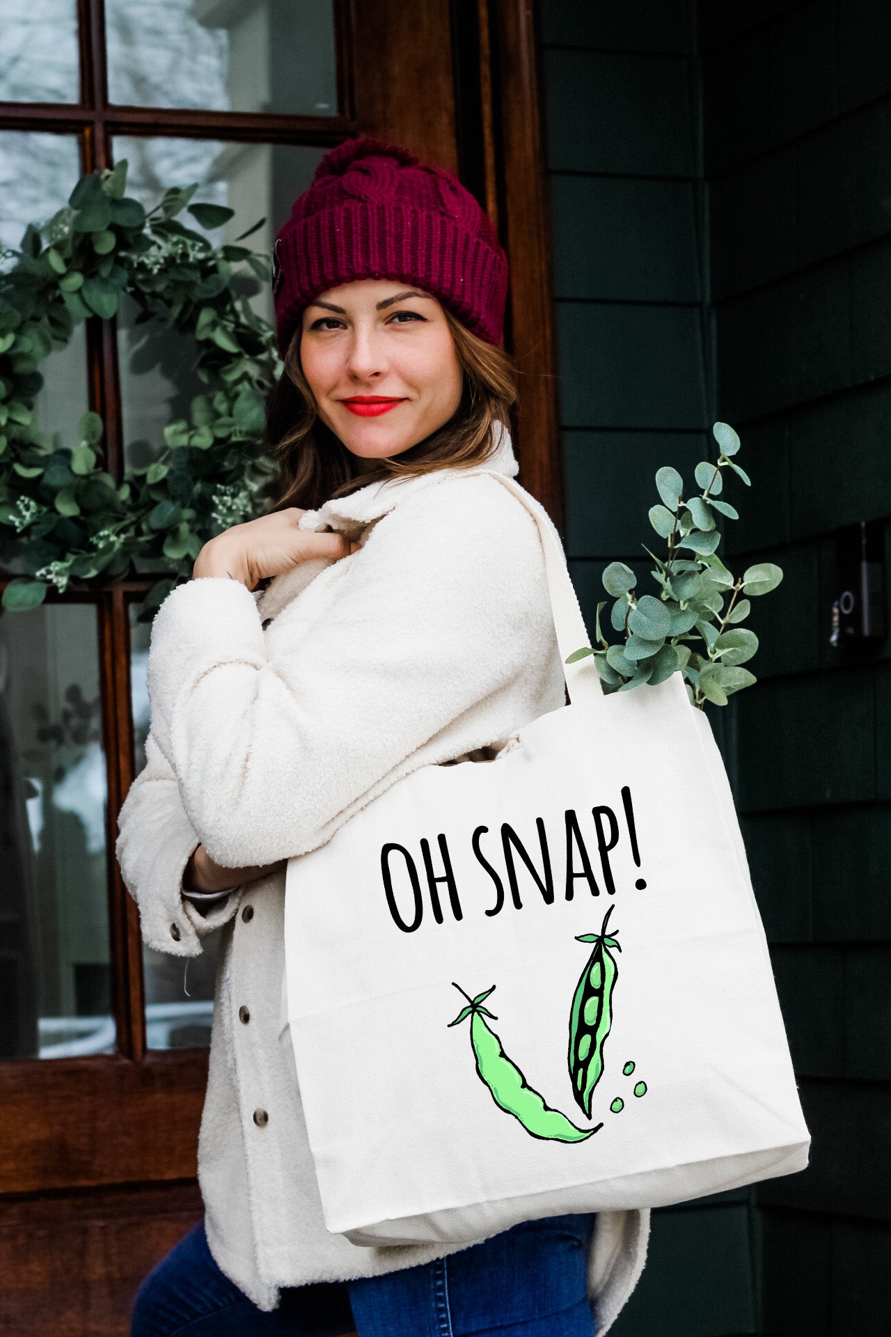 a woman carrying a bag that says oh snap