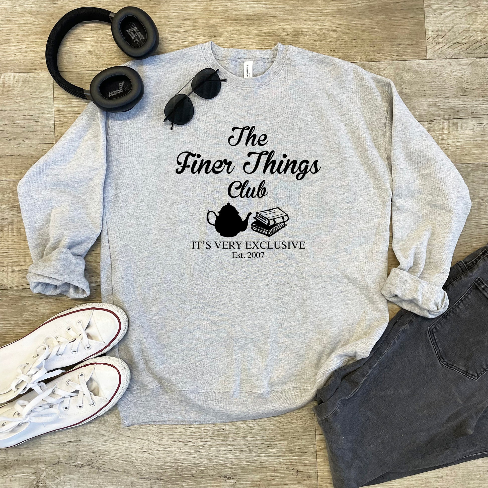 a sweatshirt with a pair of headphones and a pair of headphones