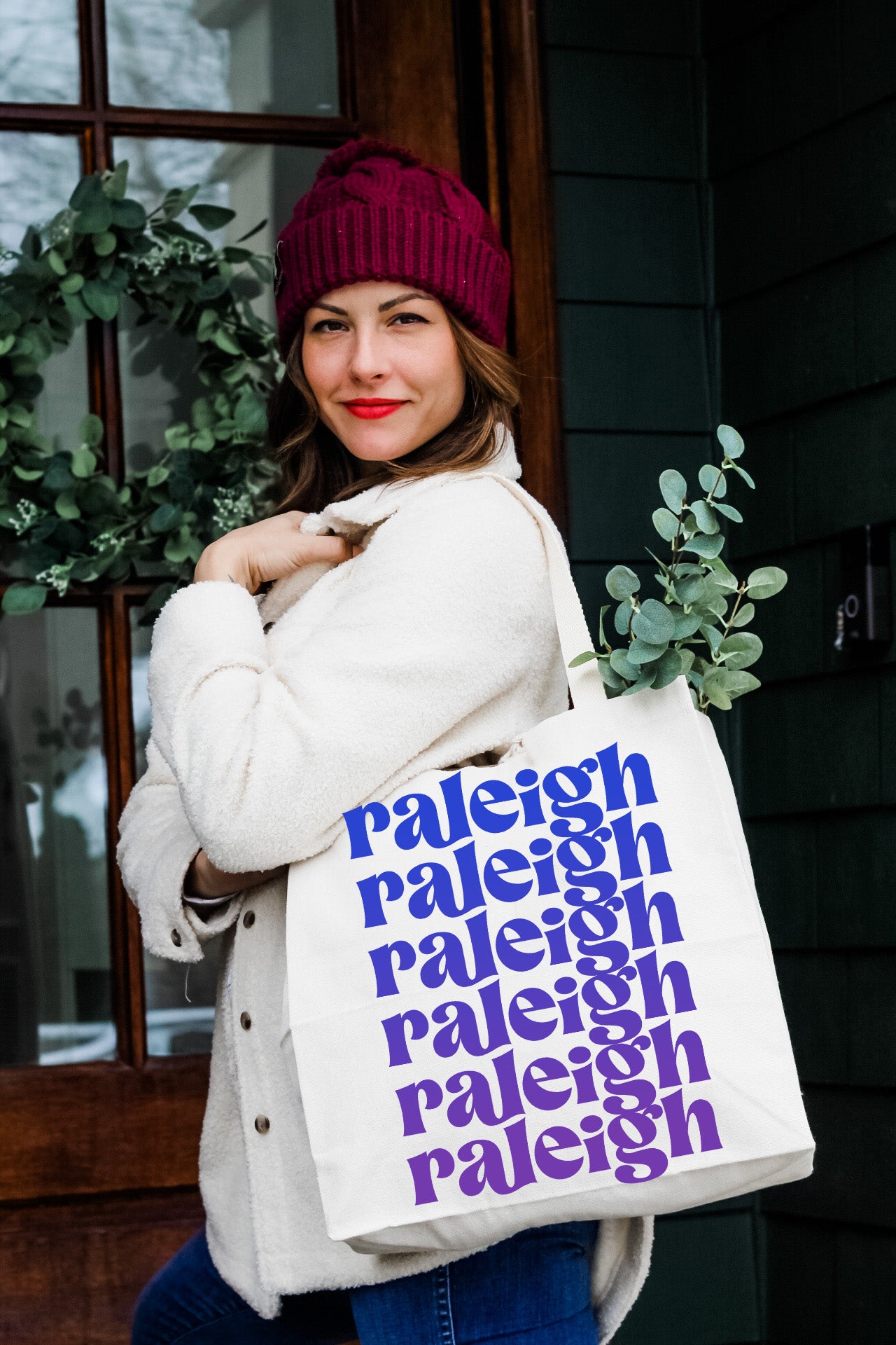 a woman is holding a bag with words on it