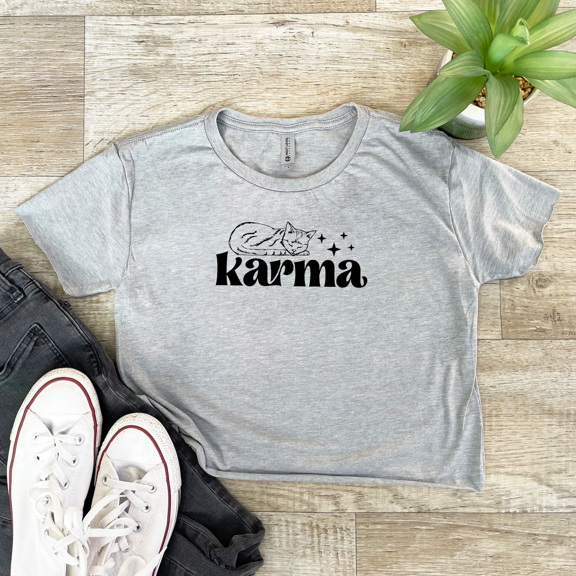 a t - shirt with the word karma printed on it next to a pair of