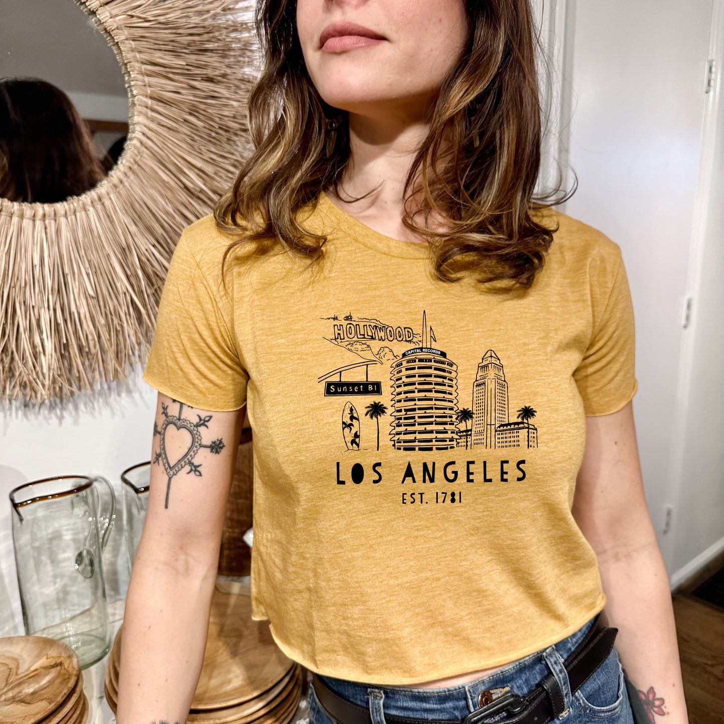 a woman wearing a yellow los angeles t - shirt