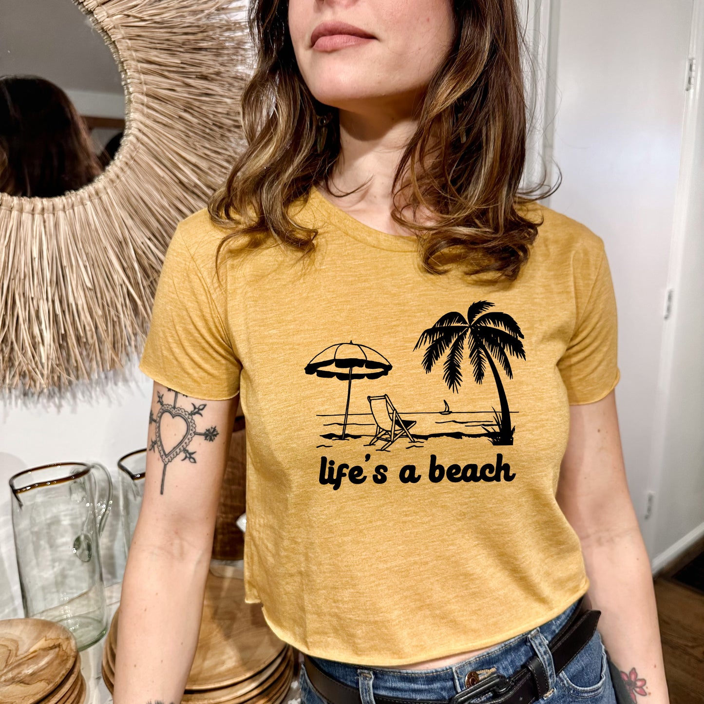 a woman wearing a life's a beach t - shirt