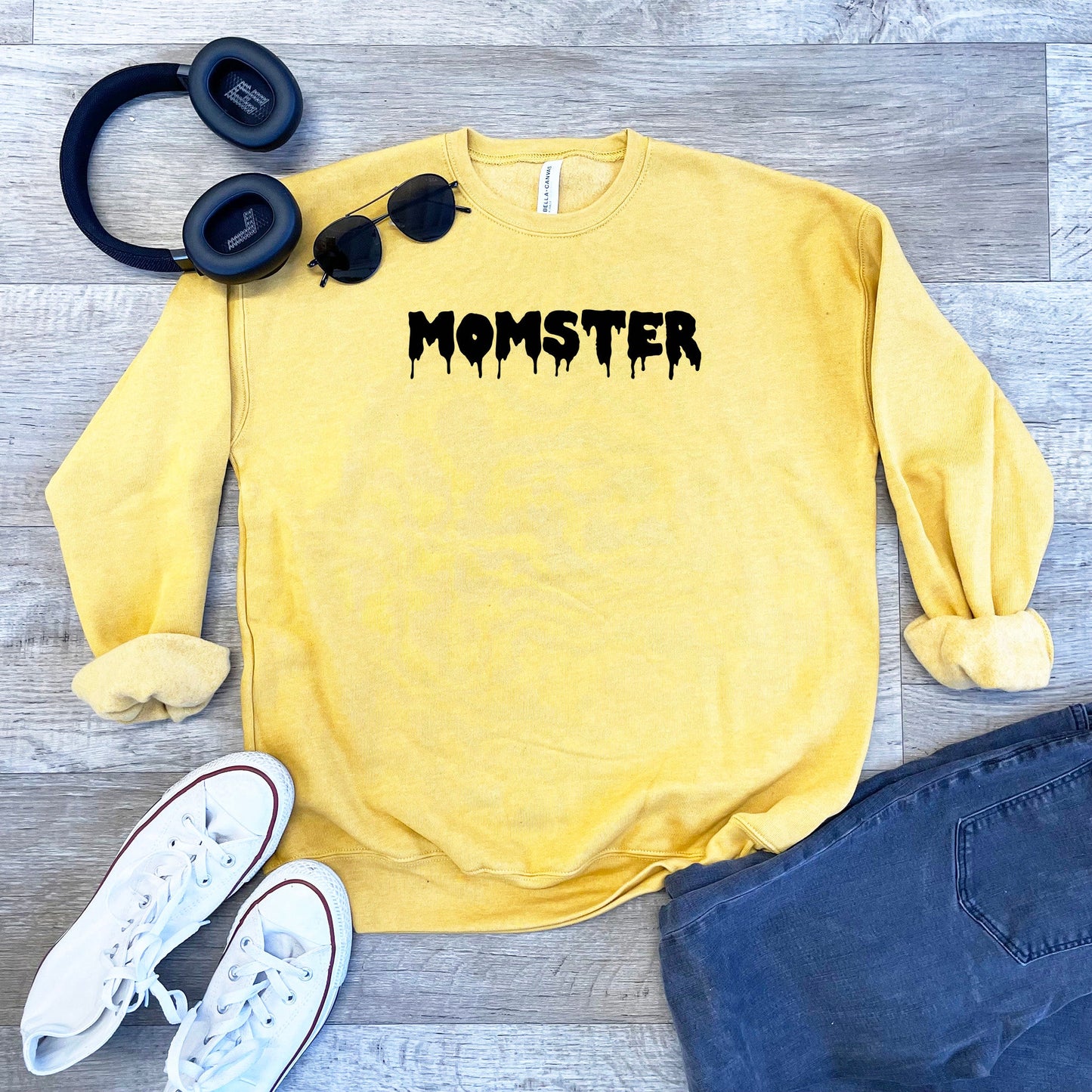 a yellow sweatshirt with the word monster on it