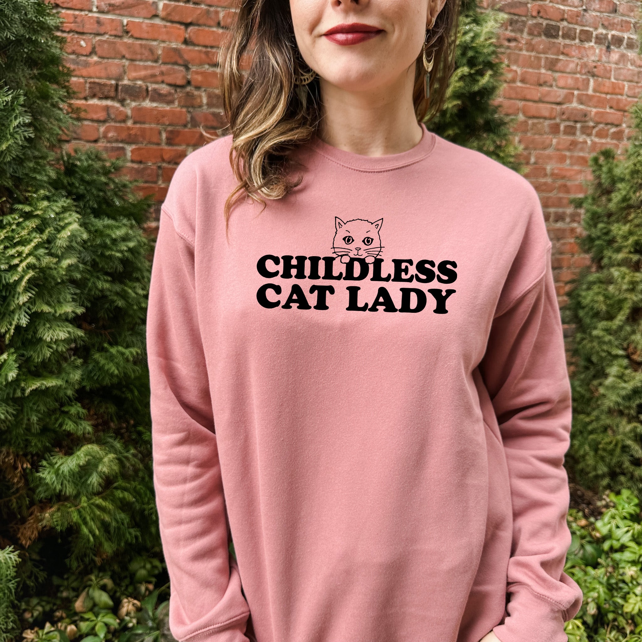 a woman standing in front of a brick wall