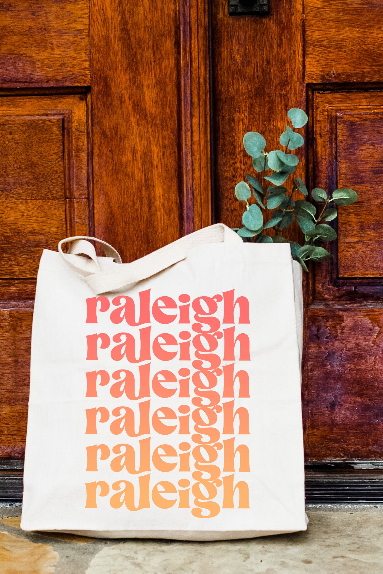 a white bag sitting on top of a wooden door