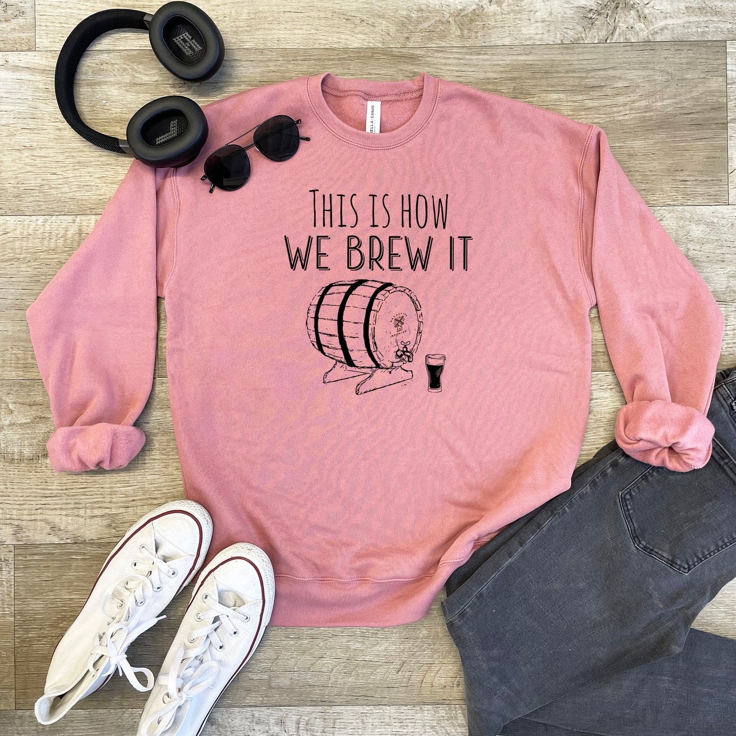 a pink sweatshirt with a picture of a barrel and headphones