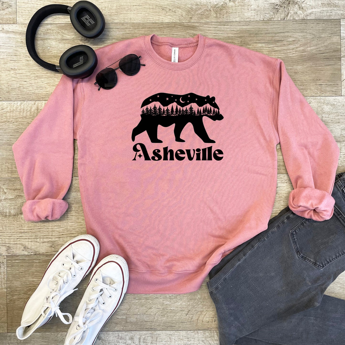 a pink sweatshirt with a bear and trees on it